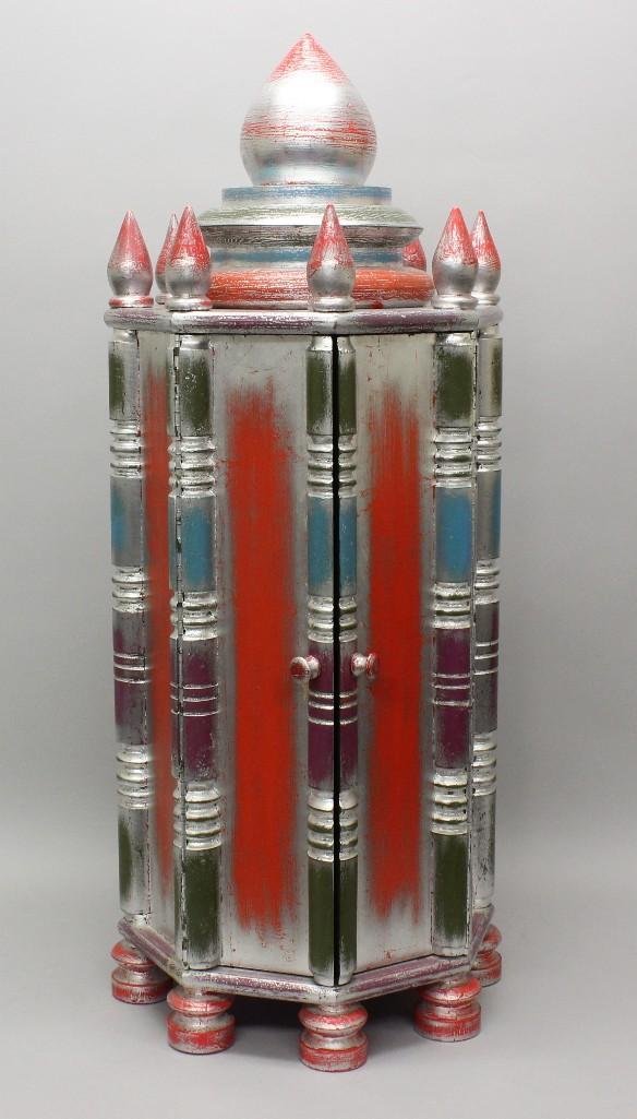 Phillip Lloyd Powell (1919-2008 Pennsylvania) Octagonal: Octagonal wooden cabinet finished in silver-leaf, rubbed to show a colorful blend of fuchsia, teal and green ground. Crowned with one central finial surrounded by eight turned finials a