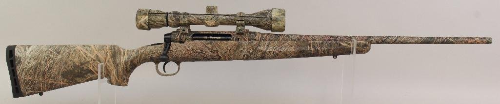 Savage Axis bolt action rifle.: Cal. 22-250. 22" bbl. SN H412881. Mossy Oak Brush camo on all surfaces, good bore and 1 - 4 round magazine. With a Bushnell 3-9 power scope with clear optics and covers. Excellent. 16-880.