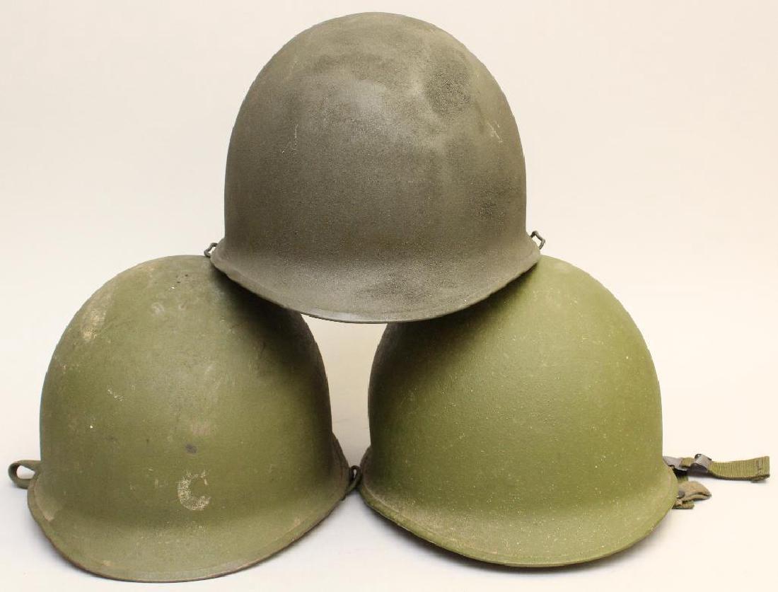 US Army Helmets: Grouping of 3 post World War II United States Army helmets with liners. Helmets exhibit some wear.
