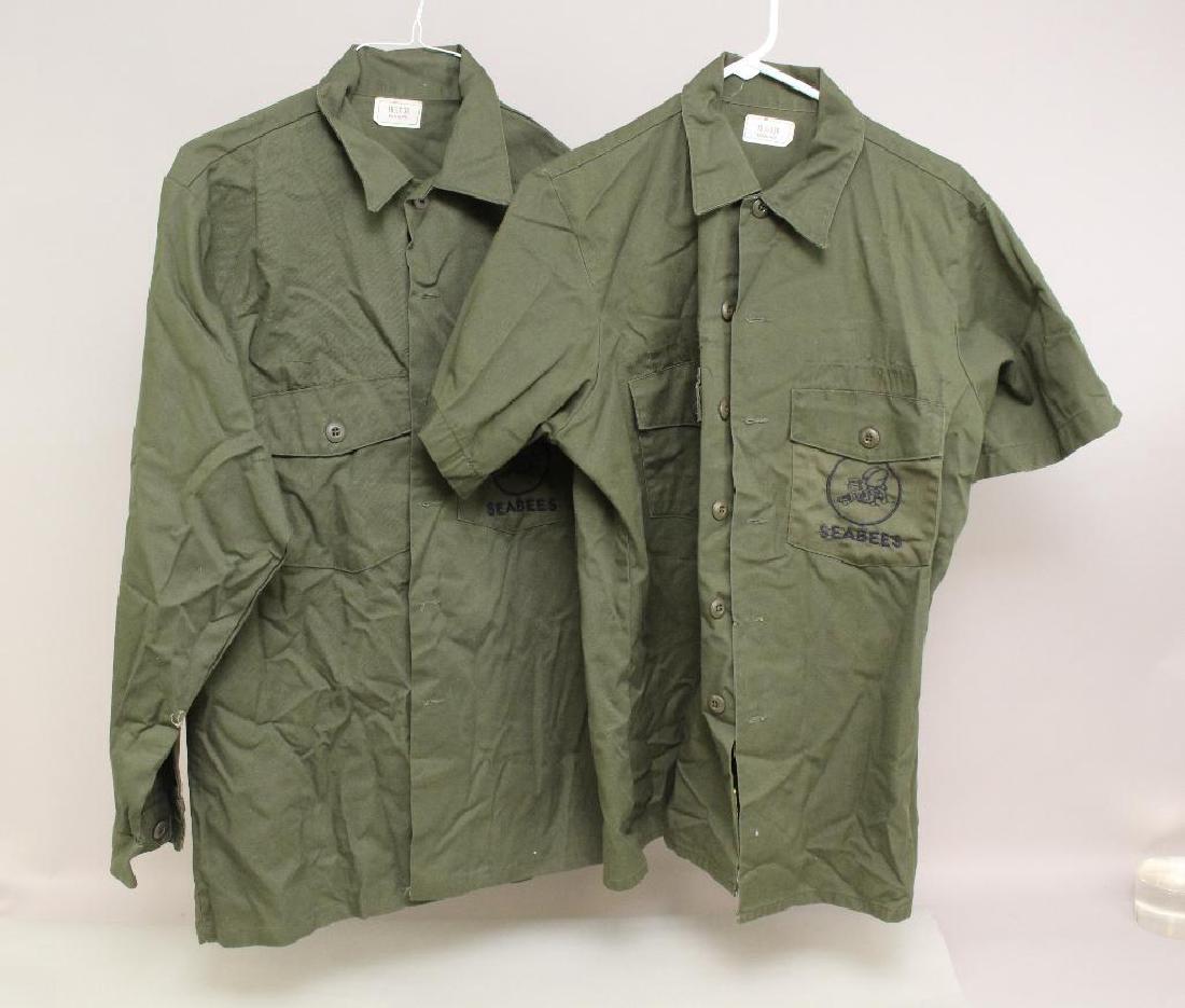 US Seabee Uniform Shirts: Pair of post World War II uniform shirts (one short sleeve and one long sleeve). Shirts present embroidered Seabee insignia on shirt pockets.