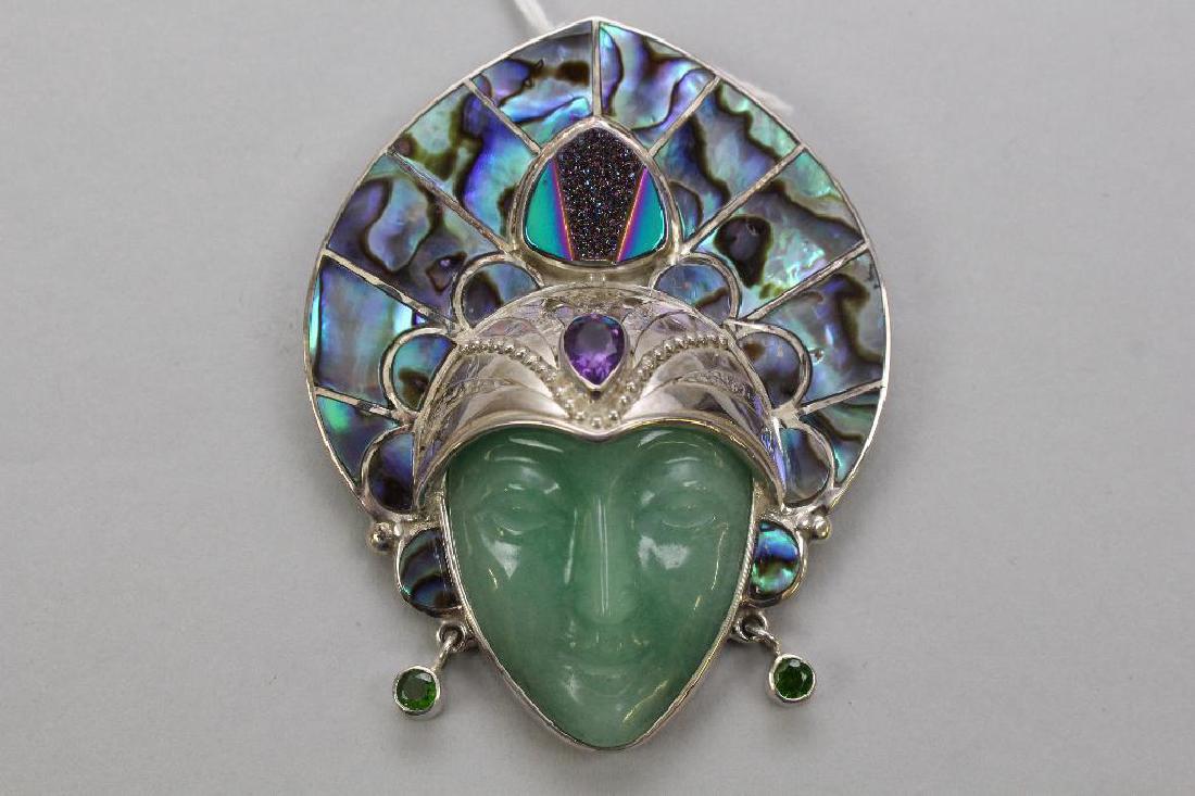 STERLING PIN/PENDANT. SAJEN. AVENTURINE, ABALONE,: 2 1/2 X 2". LOCKING C-CLASP. CARVED AVENTURINE FACE WITH ABALONE HEADDRESS. AMETHYST AND DRUZY ACCENTS. TSAVORITE(?) GREEN EARRINGS.
