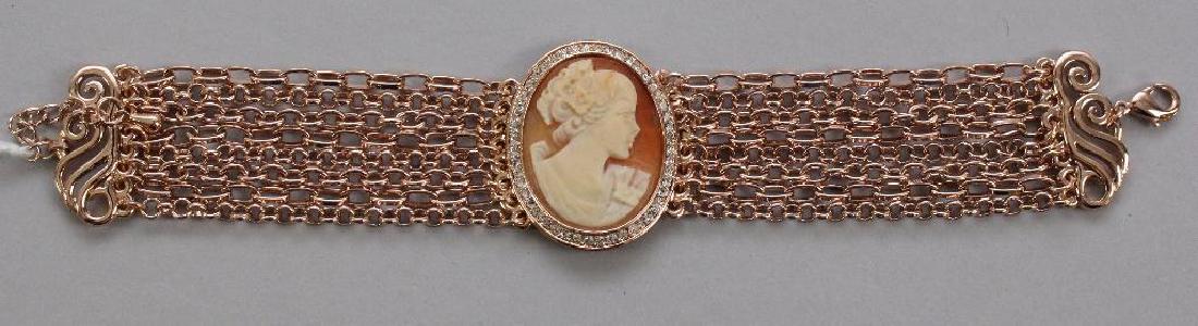 BRACELET. AMEDEO. SHELL CAMEO: 35.7 X 29MM OVAL BEZEL WITH RHINESTONES. ROSE-TONE. 8-CHAIN WITH CLAW CLASP. 7 1/2" LONG PLUS 1" EXTRA CHAIN.