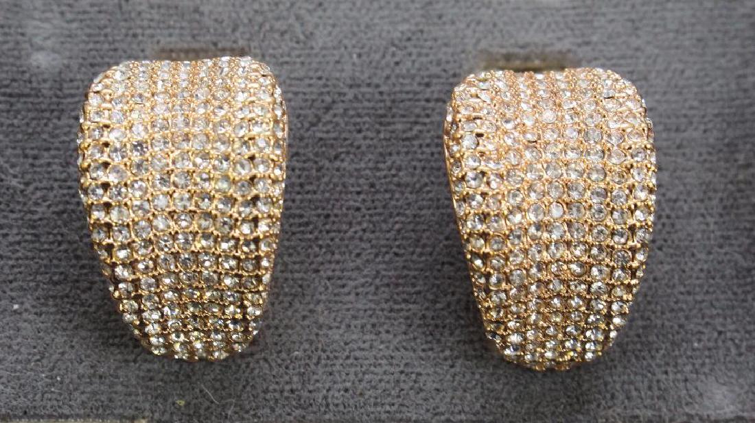 EARRINGS. JOAN BOYCE. CRYSTAL: PAVE SET CRYSTALS. ROSE-TONE. OMEGA BACK WITH POST. 1" LONG X 1/2" WIDE.