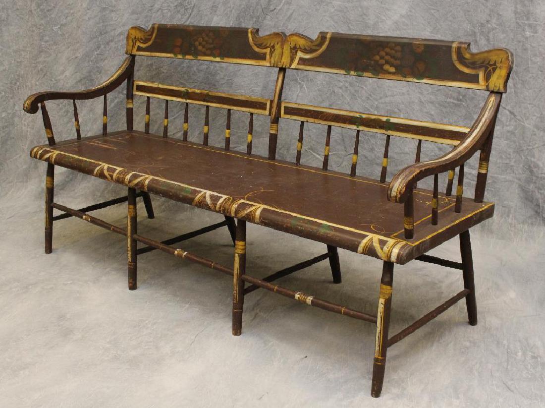 Pennsylvania Paint Decorated Deacon's Bench: Northampton County, PA. Fruit stenciled crest on brown ground with spindle back and arms on a square stretcher base, 3;5"h x 70"w x 20"d.