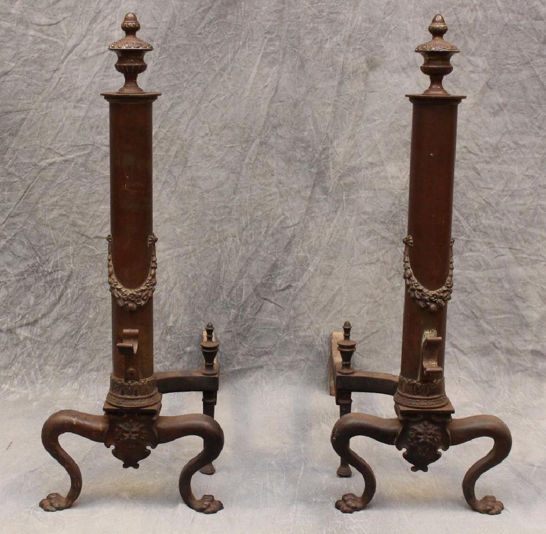 (2) Pair of Ornate Andirons: Lions head decoration on with paw feet, 24"h x 20"d. Acorn top. Brass