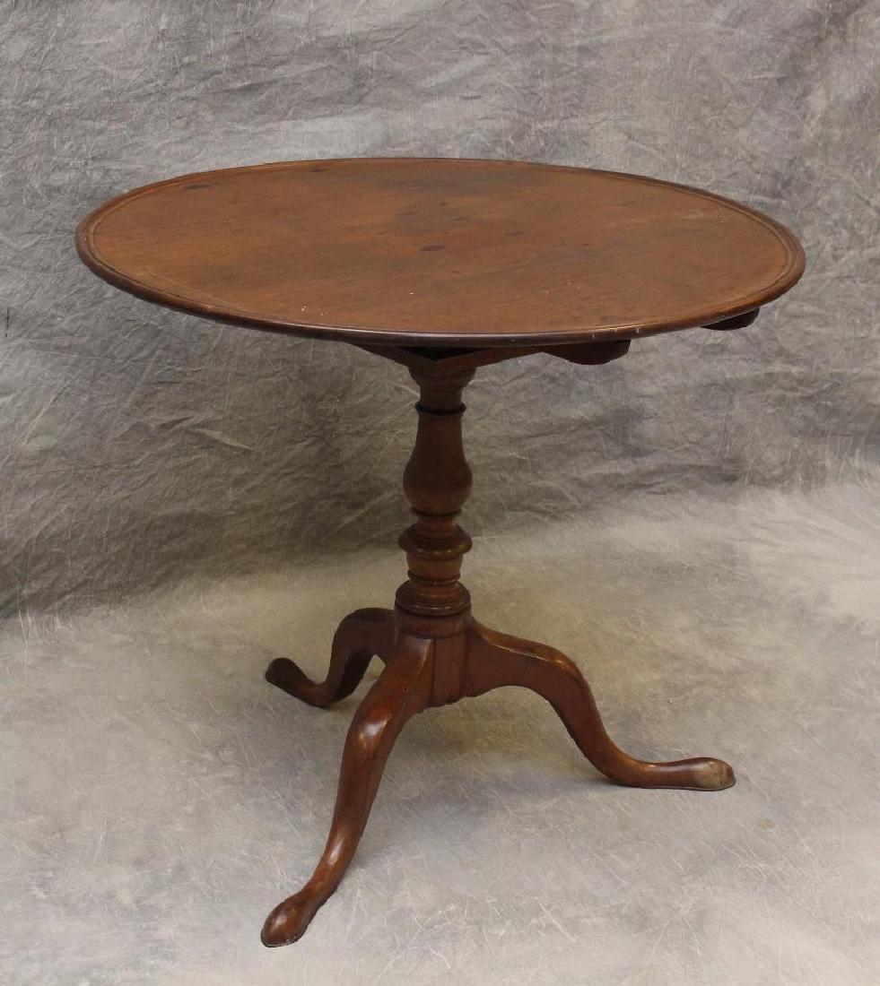 Queen Anne Style Tilt Top Tea Table: Mahogany with bird cage connection on a turned pedestal and cabriole legs, 45"h (tilt) x 31.5"rd.