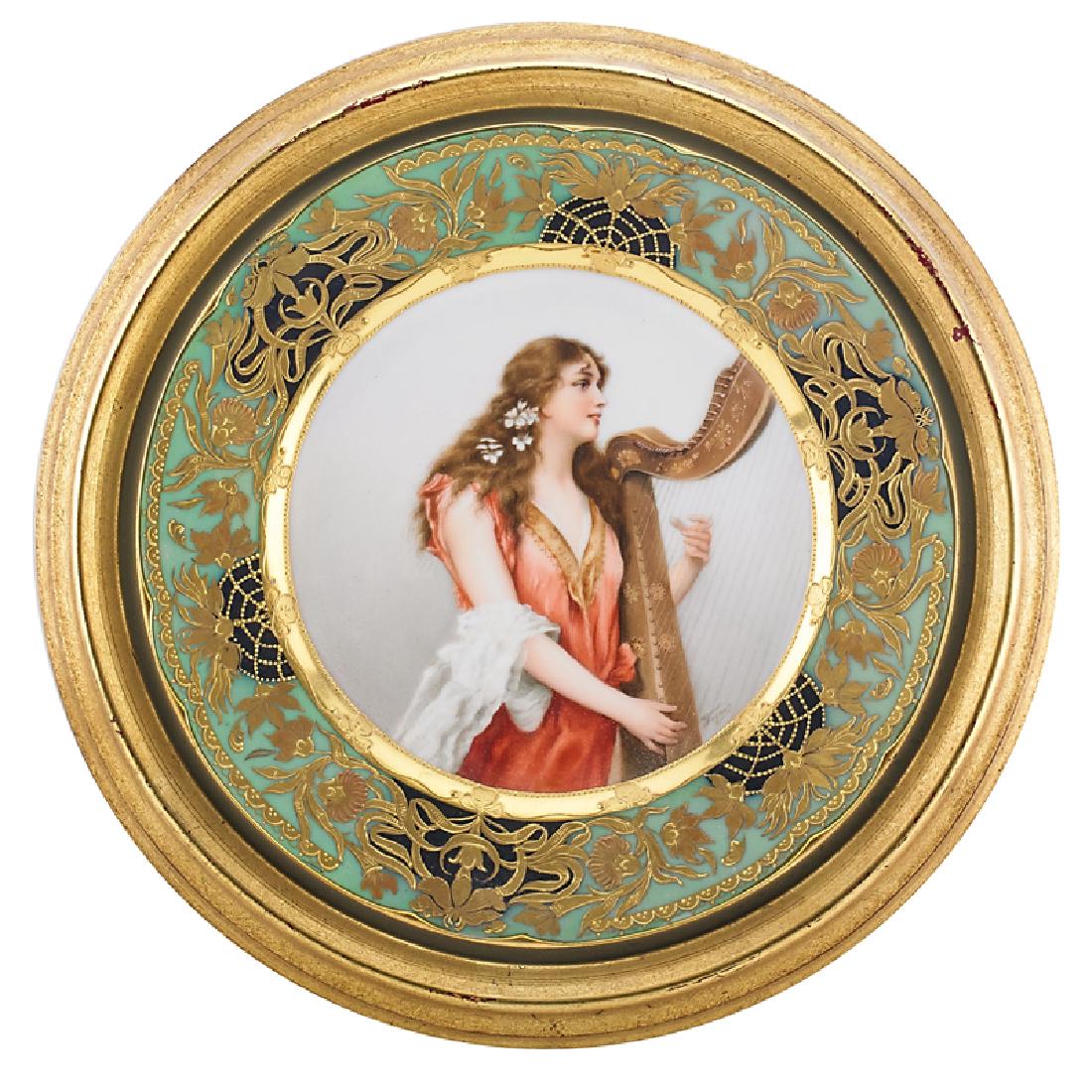 VIENNA STYLE PORCELAIN CABINET PLATE: Decorated with a maiden playing a harp, titled "Festgesong", mounted into a giltwood frame, Austria, ca. 1900 Painted mark, signed "Wagner" 9 3/4" dia. Provenance: From a private New Jersey collection