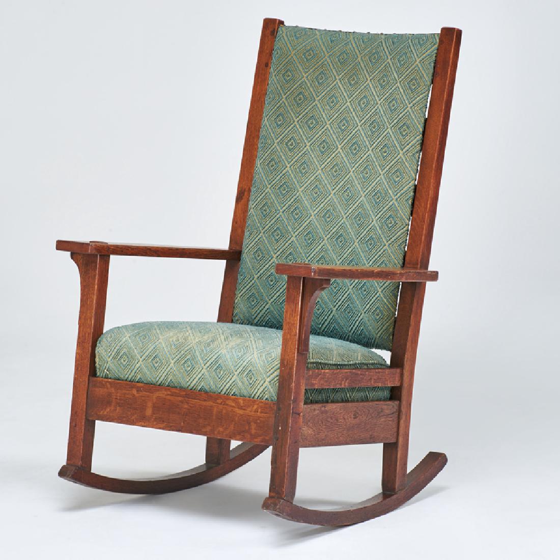 L. & J. G. STICKLEY: Ladderback arm rocker, Fayetteville, NY; ca. 1910; Quartersawn oak, tacked on upholstery; "Work of..." label; 42" x 46"