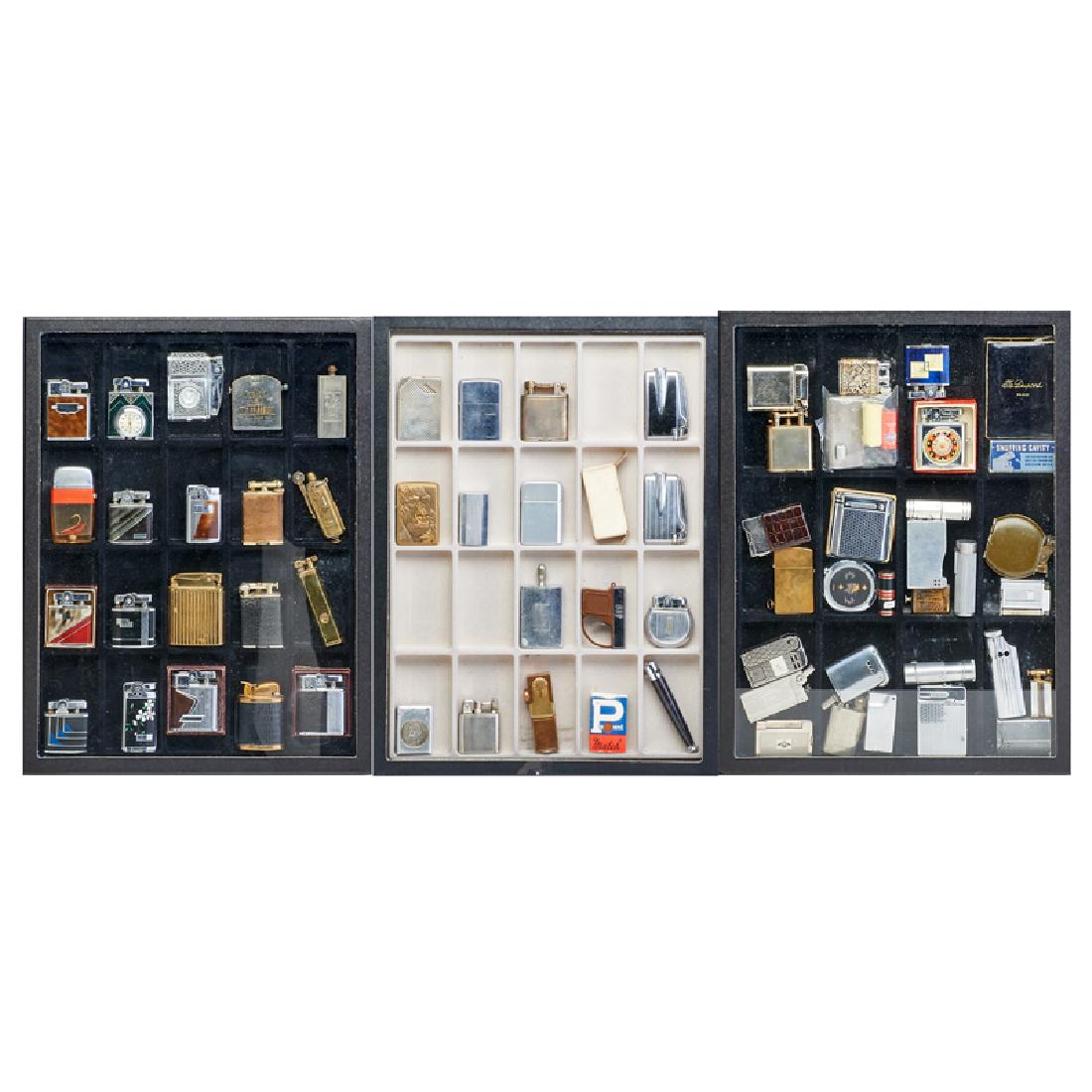 RONSON; DUNHILL; EVANS; CLARK, ETC. LIGHTERS: Sixty-seven pieces in collector's display cases, USA/England/Germany/France, etc., 20th c.; Sterling silver, 18k gold, aluminum, enameled metal, brass, leather; Most marked; Tallest: 3 1/4"