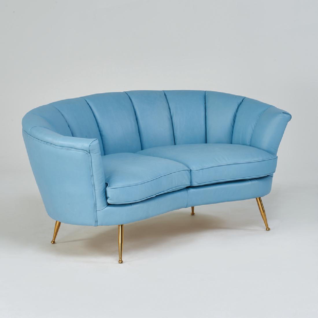 ITALIAN STYLE: Loveseat with channeled back, 2000s; Brass legs, leather upholstery; 28" x 64" x 31"
