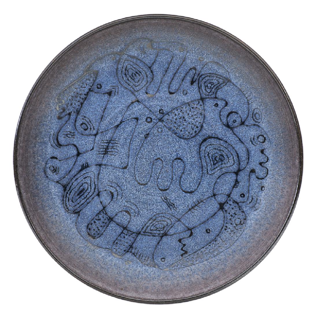 SCHEIER Early charger: EDWIN SCHEIER (1910 - 2008) MARY SCHEIER (1908 - 2007) Early glazed ceramic charger with abstract figures, New Hampshire, 1950s Incised Scheier 1" x 11"