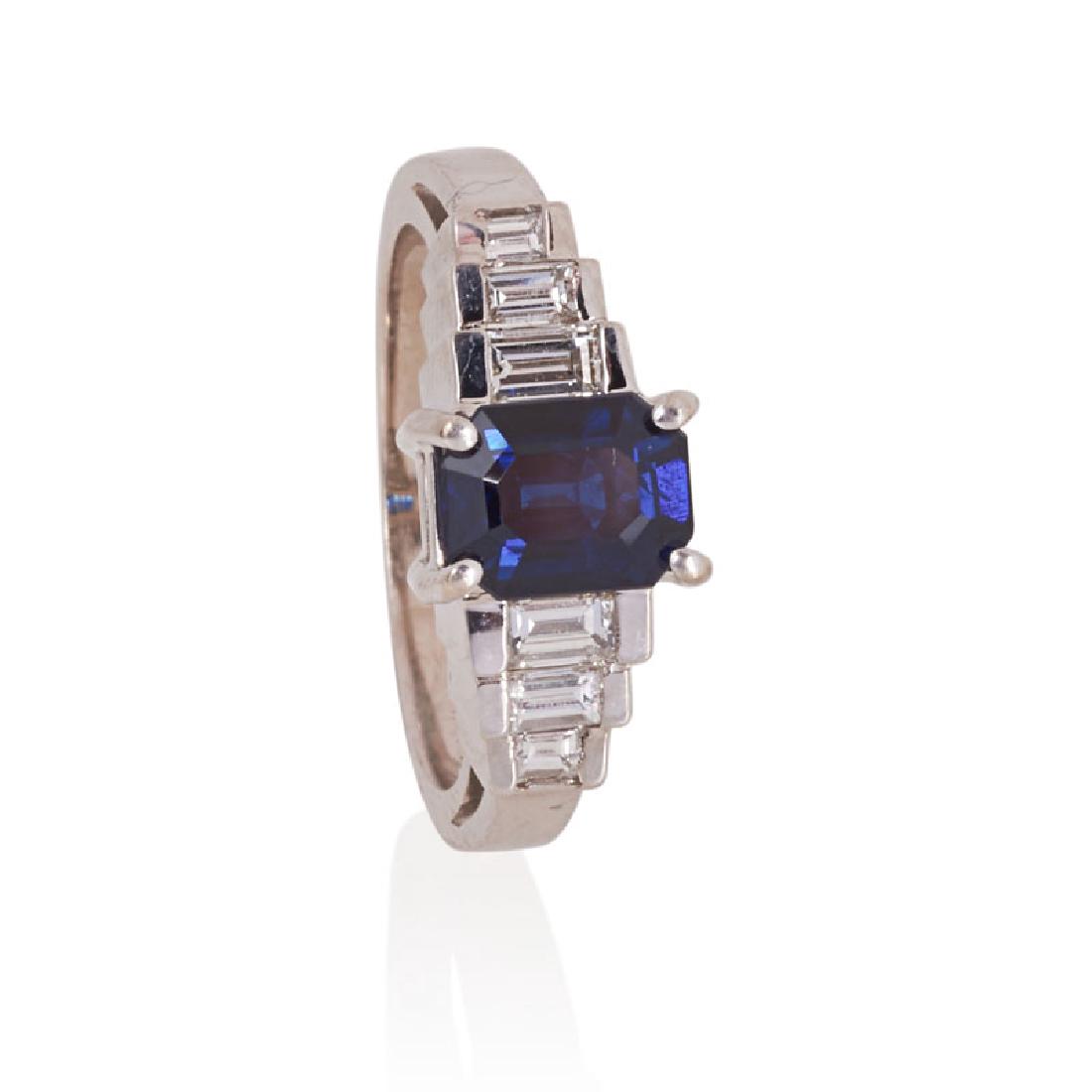 LE VIAN SAPPHIRE, DIAMOND & WHITE GOLD RING: A step cut sapphire, approx. 1.97 cts. by formula, mounted in Steps of Love setting, diamond baguettes, approx. .29 ct. TW. 18k. Stamped by maker. Size 7. 4.2 dwt.