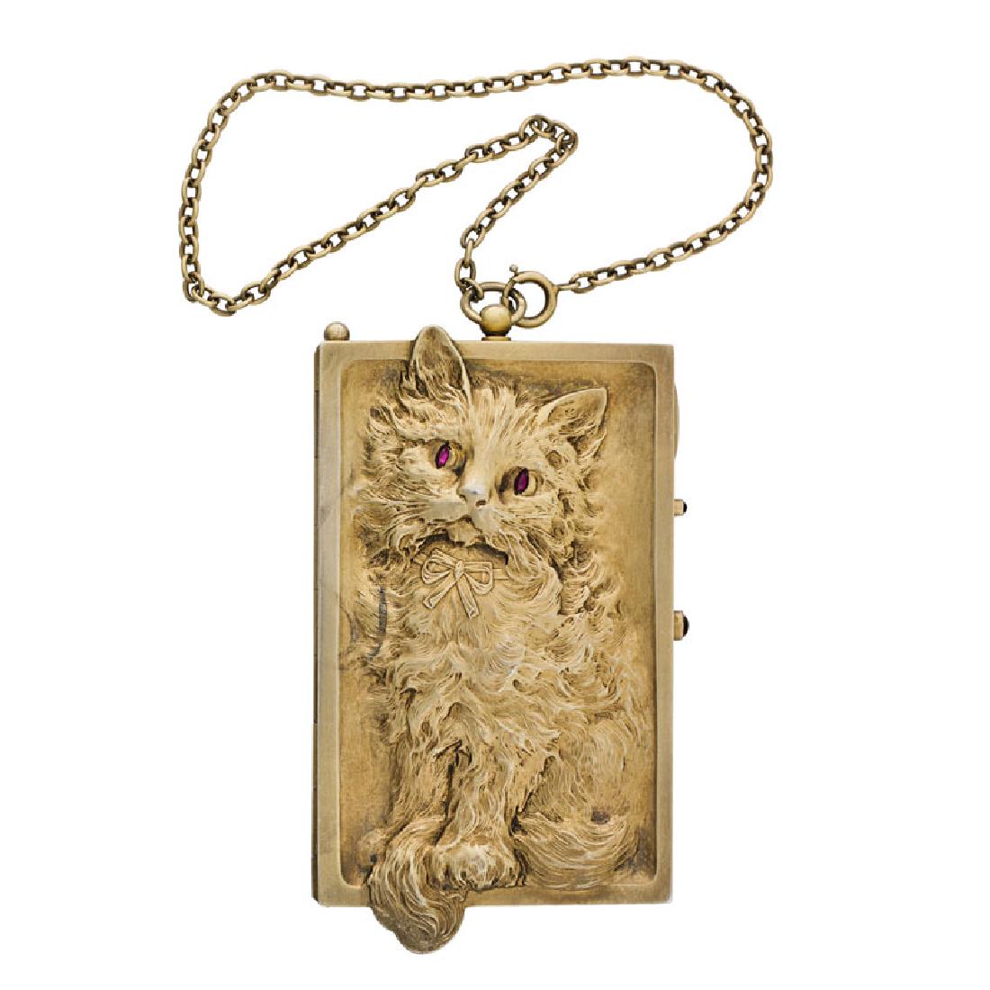 LOUIS KUPPENHEIM CAT FORM SILVER NECESSAIRE: The rectangular gilt silver design embossed to the front with a kitten with ruby eyes, the obverse depicts the kitten's back. Mirrored interior with three compartments, retractable pencil. Ca. 1920. F