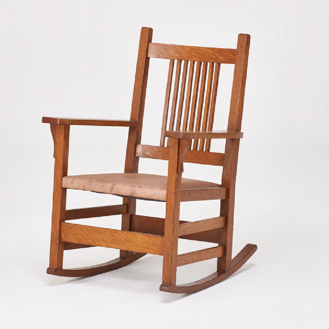 L. & J.G. STICKLEY: Youth rocker with open arms and tacked-on leather seat, East Aurora, NY Quartersawn oak "Work of..." label 31 1/2" x 22" x 24"