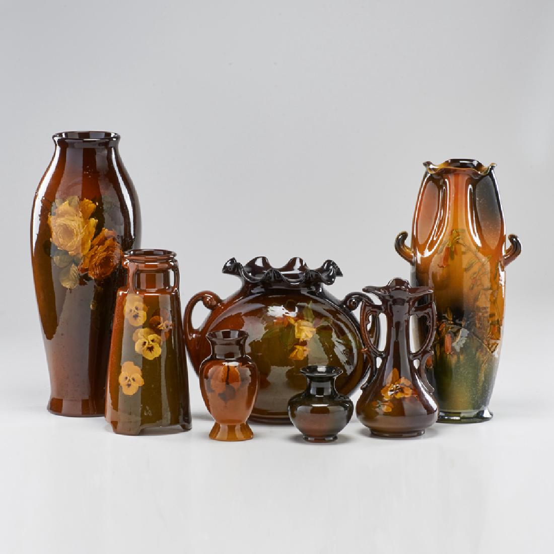 ROSEVILLE: Seven Rozane vases, most with floral or foliate decoration, Zanesville, OH, early 20th c. All but one marked, one signed by Mae Timberlake Tallest: 16 1/2"