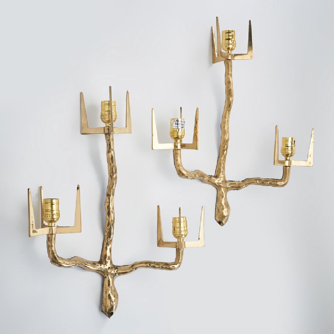 STYLE OF FELIX AGOSTINI: Pair of trident shaped sconces, 2000s Brass-plated metal Unmarked 20" x 16" each.