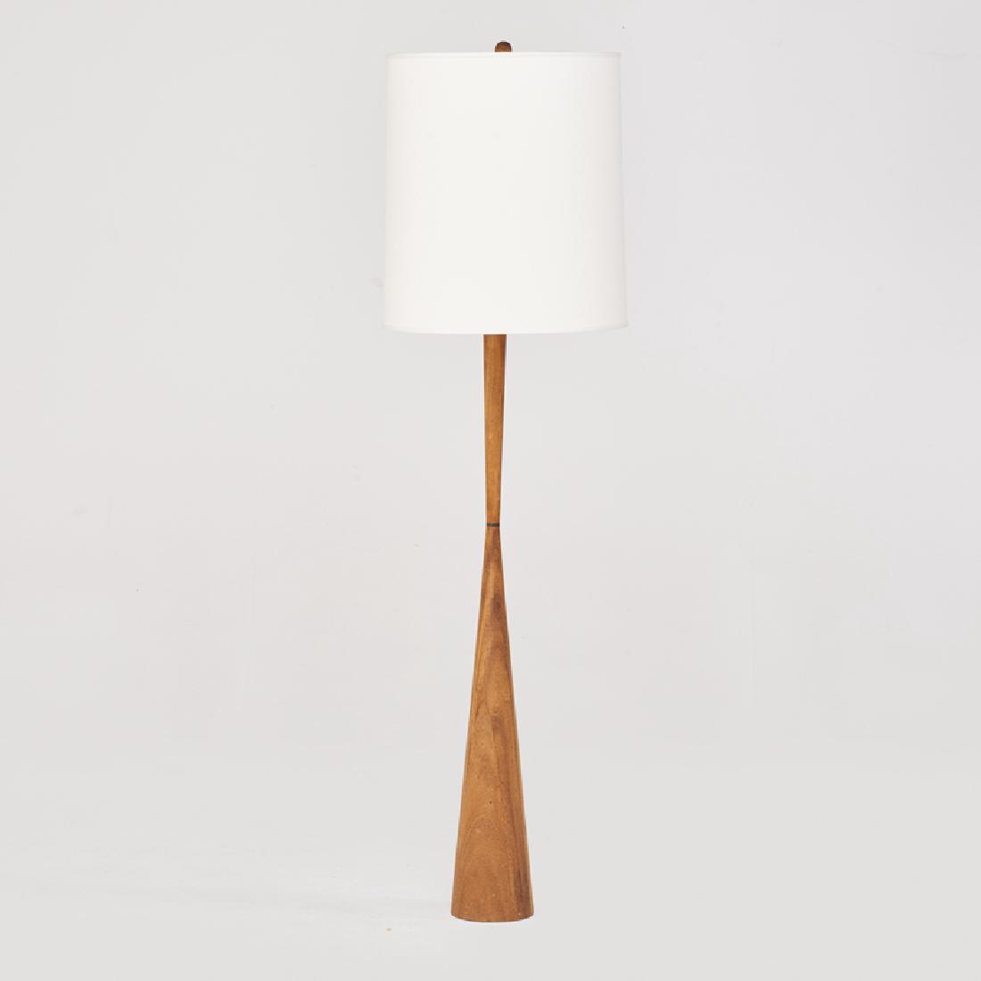 STYLE OF PHIL POWELL: Floor lamp, USA, 1960s/70s Turned wood, brass, linen shade Unmarked 65" x 18" dia.