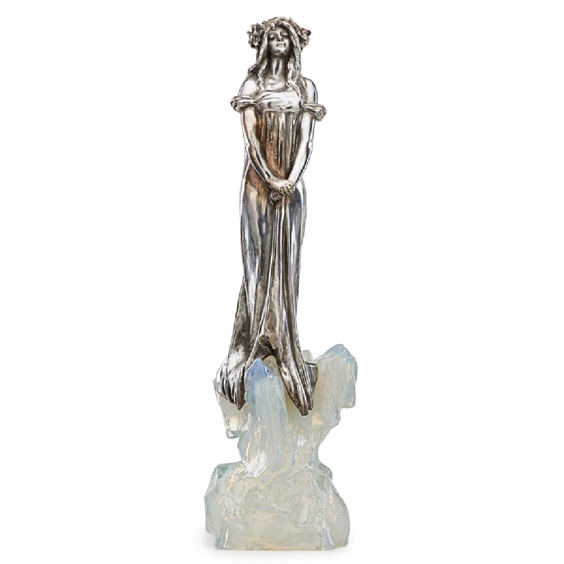 JULIEN CAUSSE Sculpture, "La Fée des Glace": JULIEN CAUSSE (1869 - 1909) "La Fée des Glaces," France, ca. 1900 Pewter, opalescent glass Impressed J. CAUSSE 23" x 7" Literature: Macklowe and Goldring, Dynamic Beauty: Sculpture of Art Nouveau Par