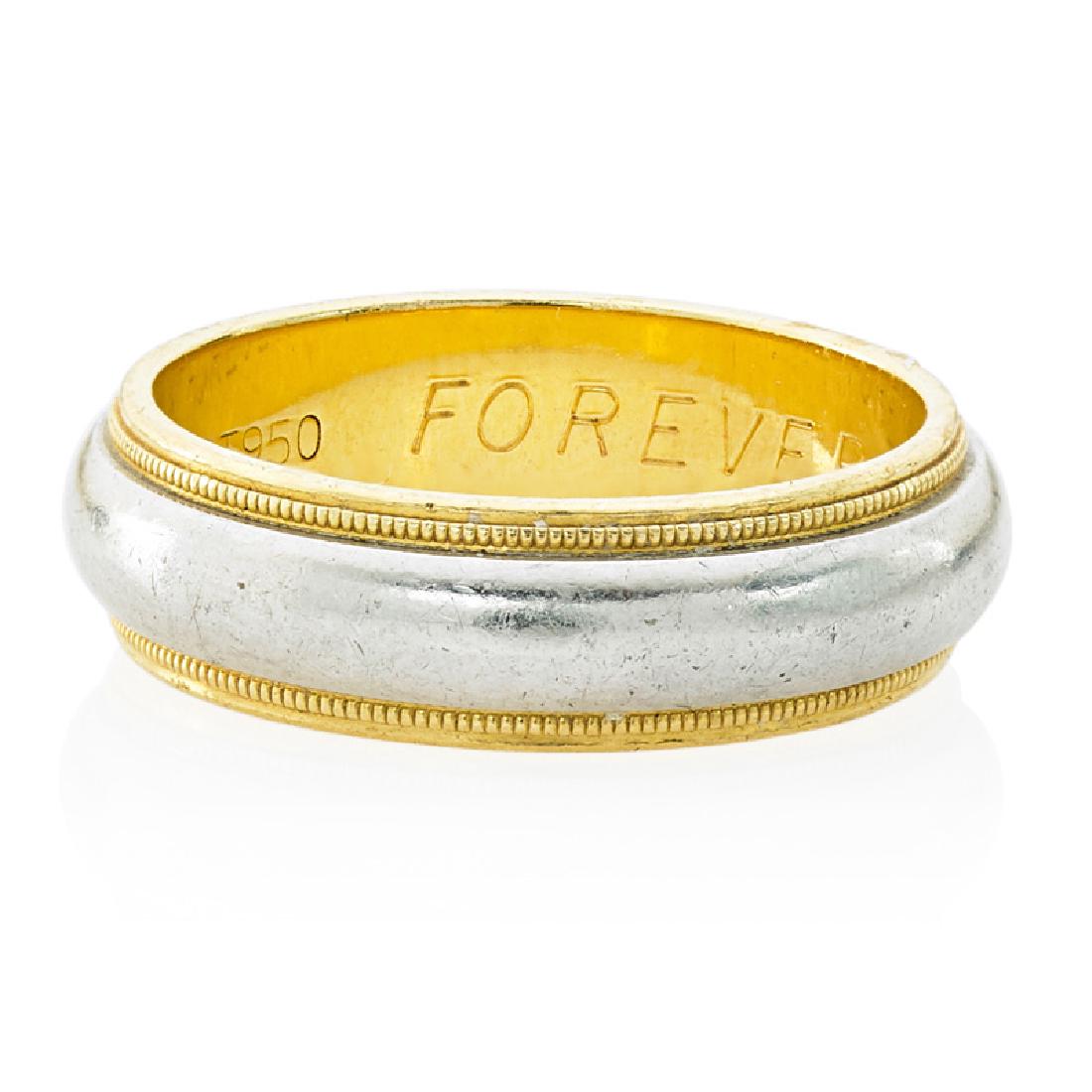 GENTLEMAN'S TIFFANY & CO. WEDDING BAND RING: The "Tiffany's Classic" bright platinum band between two lines of millegrained yellow gold. 18k. Size 8. 6.4 dwt.