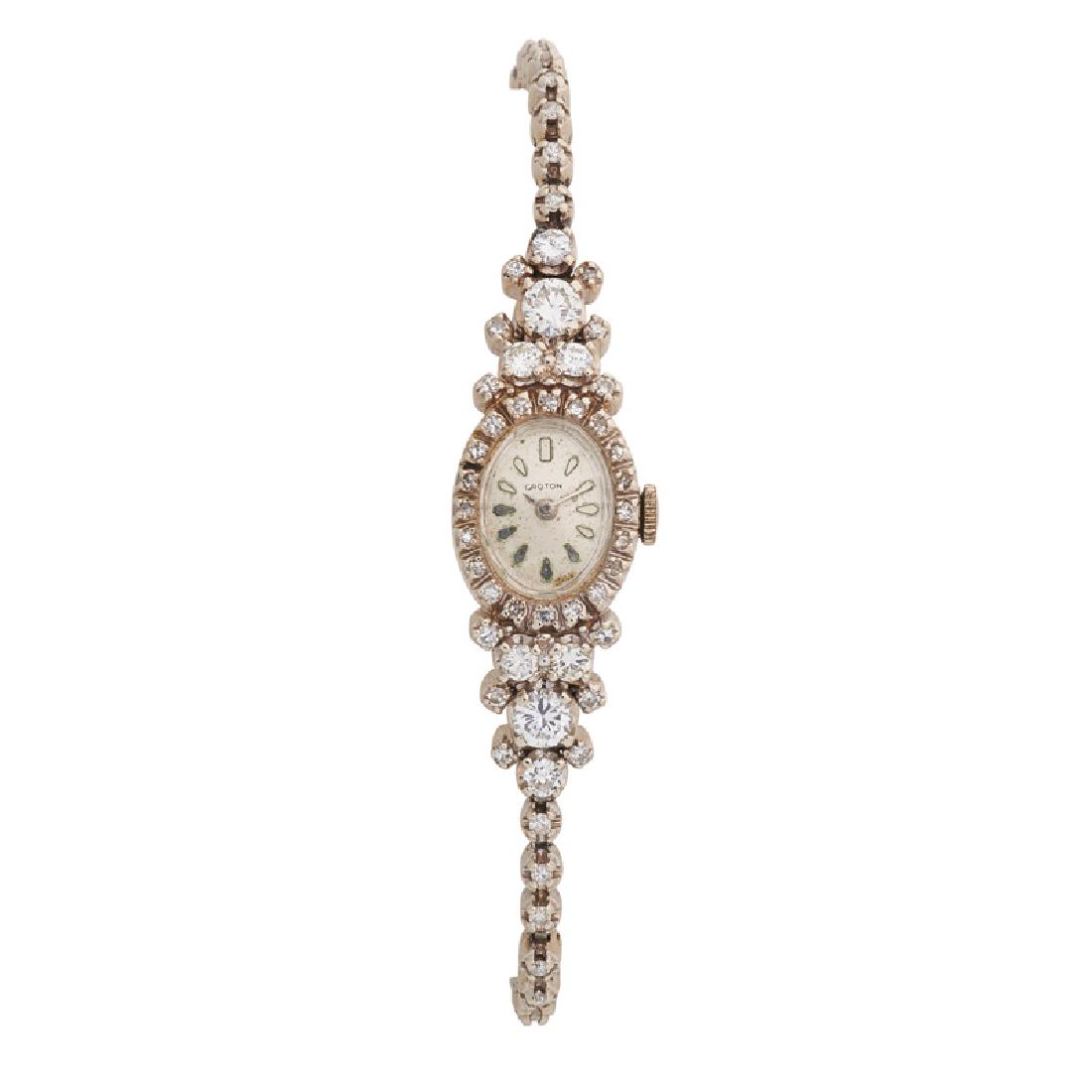 LADY'S DIAMOND & WHITE GOLD BRACELET WATCH: The oval Croton with gold dash hours, a seventeen jeweled movement, in single cut diamond case with RBC diamond cluster lugs, on single cut diamond line bracelet, approx. 3.55 cts. TW. 14k. 7". 11.8 d