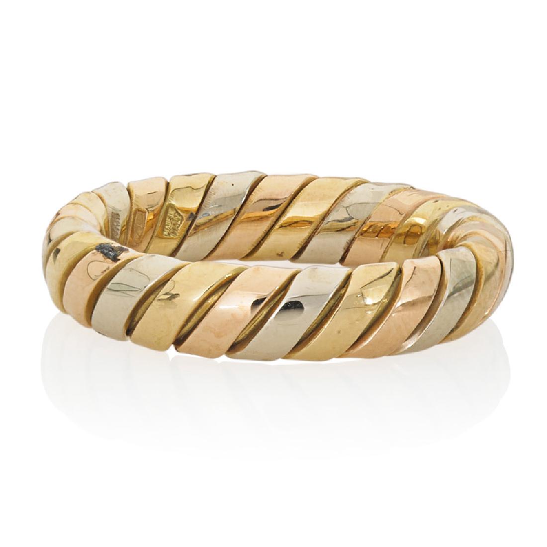 BVLGARI TRICOLOR GOLD "TUBOGAS" RING: Designed in yellow, rose, and white gold. 18k. Stamped Bvlgari, with Italian control mark. Size 6. 4.0 dwt.