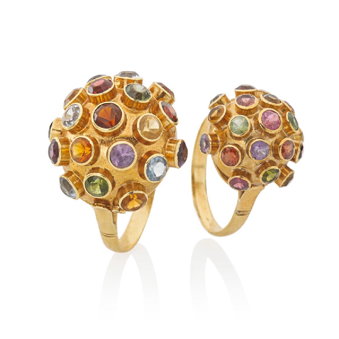 GEM SET YELLOW GOLD SPUTNIK STYLE RINGS: The two rings with bezel set round faceted amethyst, citrine, garnet, aquamarine, or peridot. 18k. Sizes 5 1/4, 8 1/2. 4.5 dwt.