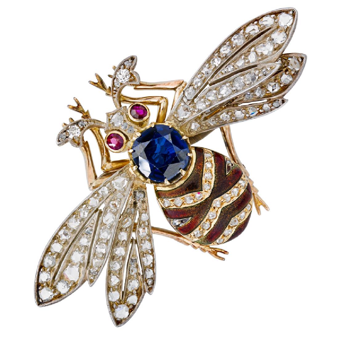 EDWARDIAN DIAMOND & GEM SET YELLOW GOLD BEE BROOCH: With a round faceted flux sapphire thorax, striped brown guilloché enamel or rose cut diamond abdomen, rose cut diamond pierced platinum topped wings, and round faceted ruby eyes. 18k. 1 1/4" x 2". 9
