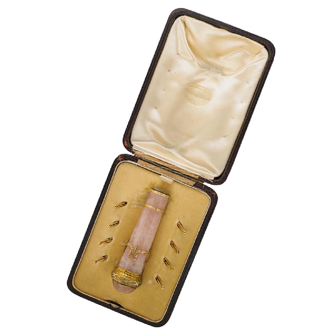 MELLERIO DITS MELLER GOLD & QUARTZ PARASOL SET: The rose quartz handle with bicolor gold mounts in the garland style accompanied by eight gold tips. Ca. 1905, Paris. French eagle marks for 18k gold throughout. Handle 3 3/4", tips 3/4". In fitted bo