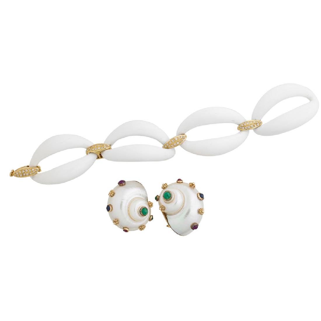 DIAMOND OR GEM SET SHELL OR AGATE JEWELRY: A pair of turbo shell earrings with yellow gold bezel set round emerald, ruby or sapphire cabochons and applied granulated gold accents, in the style of Seaman Schepps; A carved white agate link brace