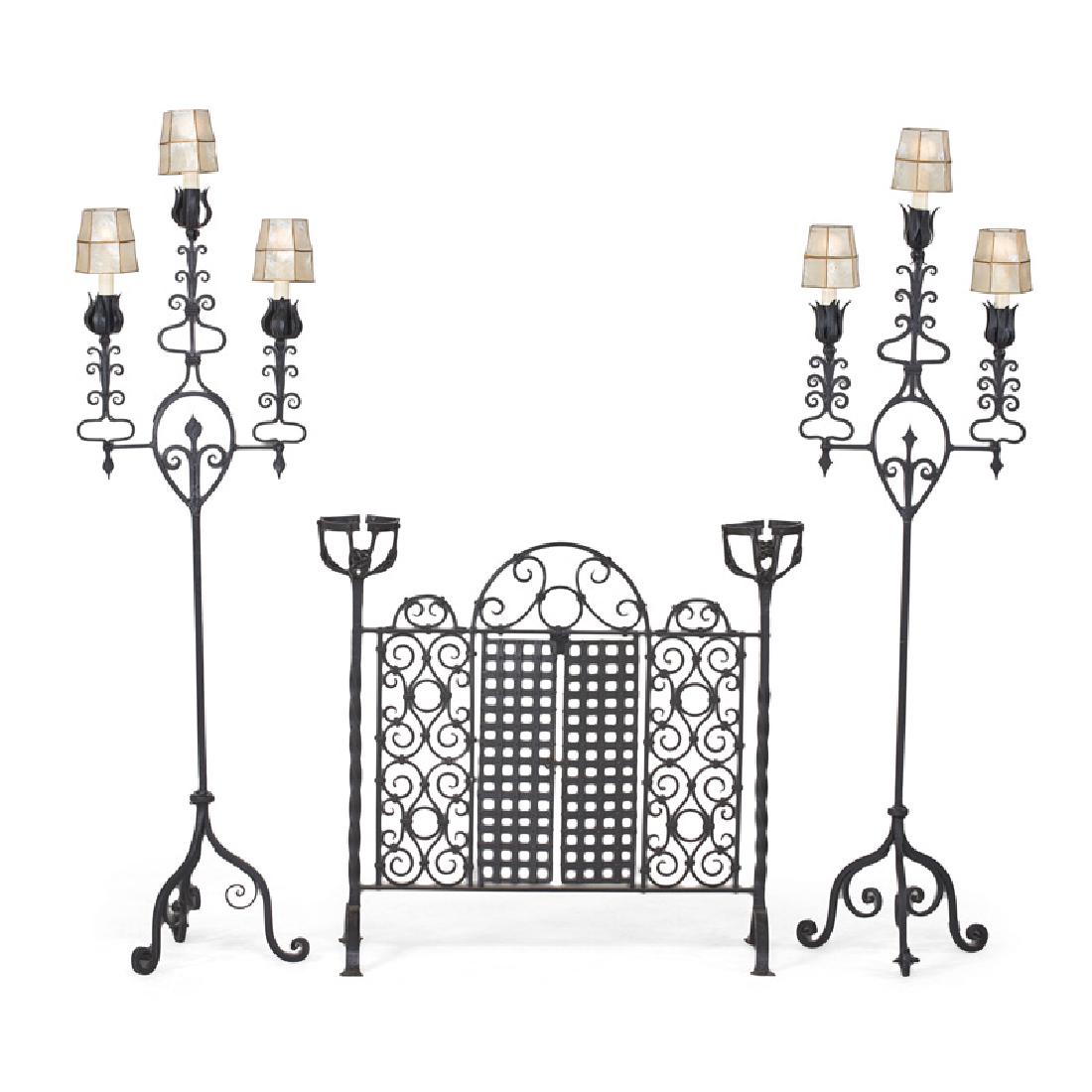 WROUGHT IRON FIREPLACE ACCESSORIES: Three: Pair of Gothic Revival three-light torcheres and firescreen, 20th c. Torcheres: 68 1/2"