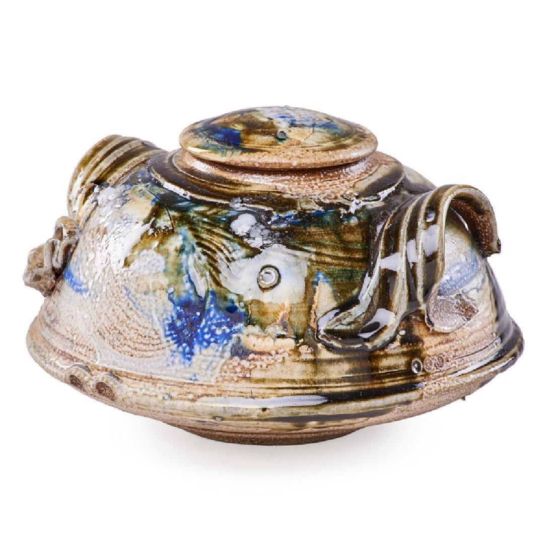 DON REITZ LIDDED STONEWARE VESSEL: With two handles, in a polychrome glaze, raised on a circular foot, Pennsylvania, 1973 7" x 11" dia. Note: Original 1973 receipt included