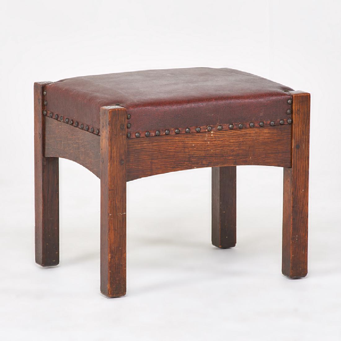 L. & J.G. STICKLEY: Foot stool with arched apron, Fayetteville, NY, ca. 1910 Quartersawn oak, oil cloth, brass tacks Unmarked 16 1/2" x 19" x 15"
