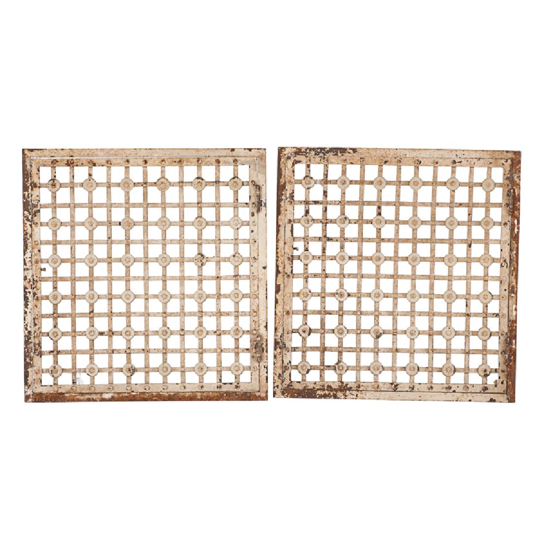SAMUEL YELLIN (1885-1940) (Attr.): Pair of hinged grates with strapwork and medallions, Philadelphia, PA Enameled iron 28 1/2" x 29 1/2" x 2 1/2"