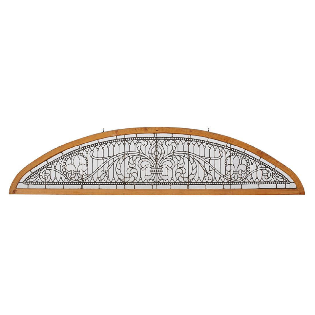 ARCHITECTURAL: Arched leaded glass transom with fleur-de-lis and scrollwork motif Hammered "cracked ice" and textured glass, glass jewels, leading, new pine frame 23 1/2" x 100 1/2" x 1 3/4"
