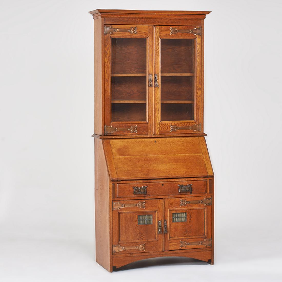 ENGLISH ARTS & CRAFTS: Drop-front secretary with two upper doors, single drawer, and lower cabinet, early 20th c. Quartersawn oak, copper repoussé hardware, leaded slag glass, glass Unmarked 84 1/2" x 37 1/2" x 18"