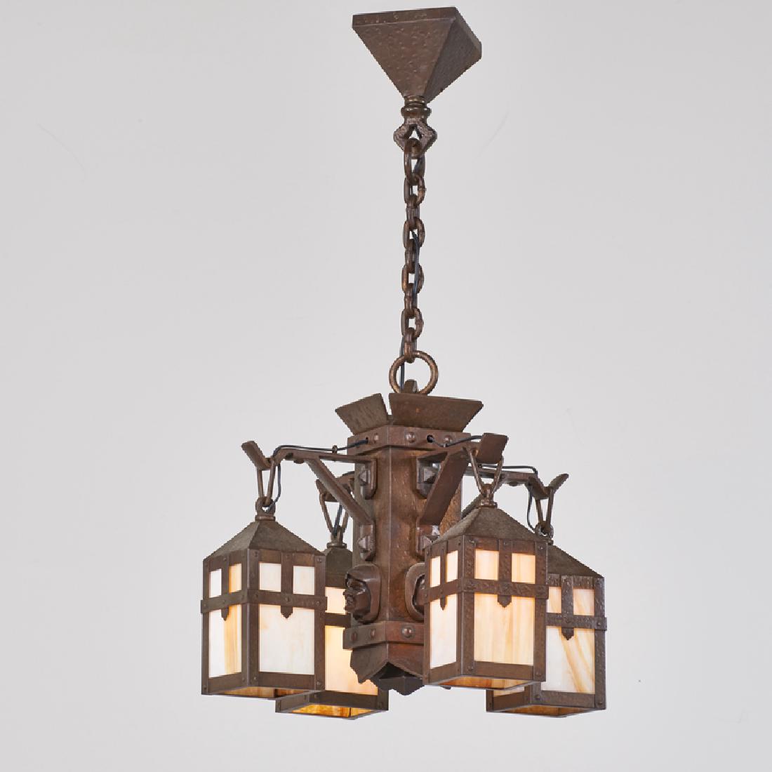 ARTS & CRAFTS: Four pendant chandelier with monk head medallions (en-suite with preceding), 20th c. Patinated metal, caramel slag glass Unmarked 34" x 21" dia