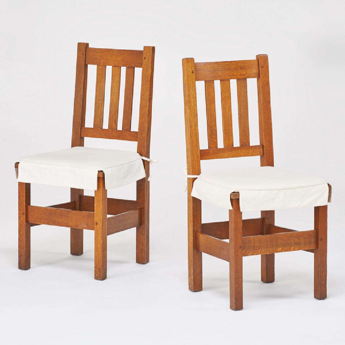 STICKLEY BROTHERS: Pair of side chairs with three vertical backslats, Grand Rapids, MI, ca. 1912 Quartersawn oak, tied-on upholstery seats Quaint metal tag 37" x 18" x 17"