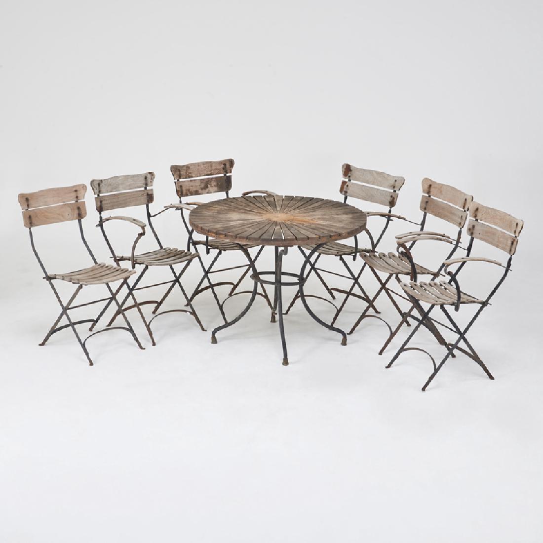 FRENCH: Seven-piece garden set: six folding armchairs with circular dining table, 1940s/50s Wrought iron, oak Unmarked 30" x 20" x 21", table: 30 1/2" x 39 1/2" dia.