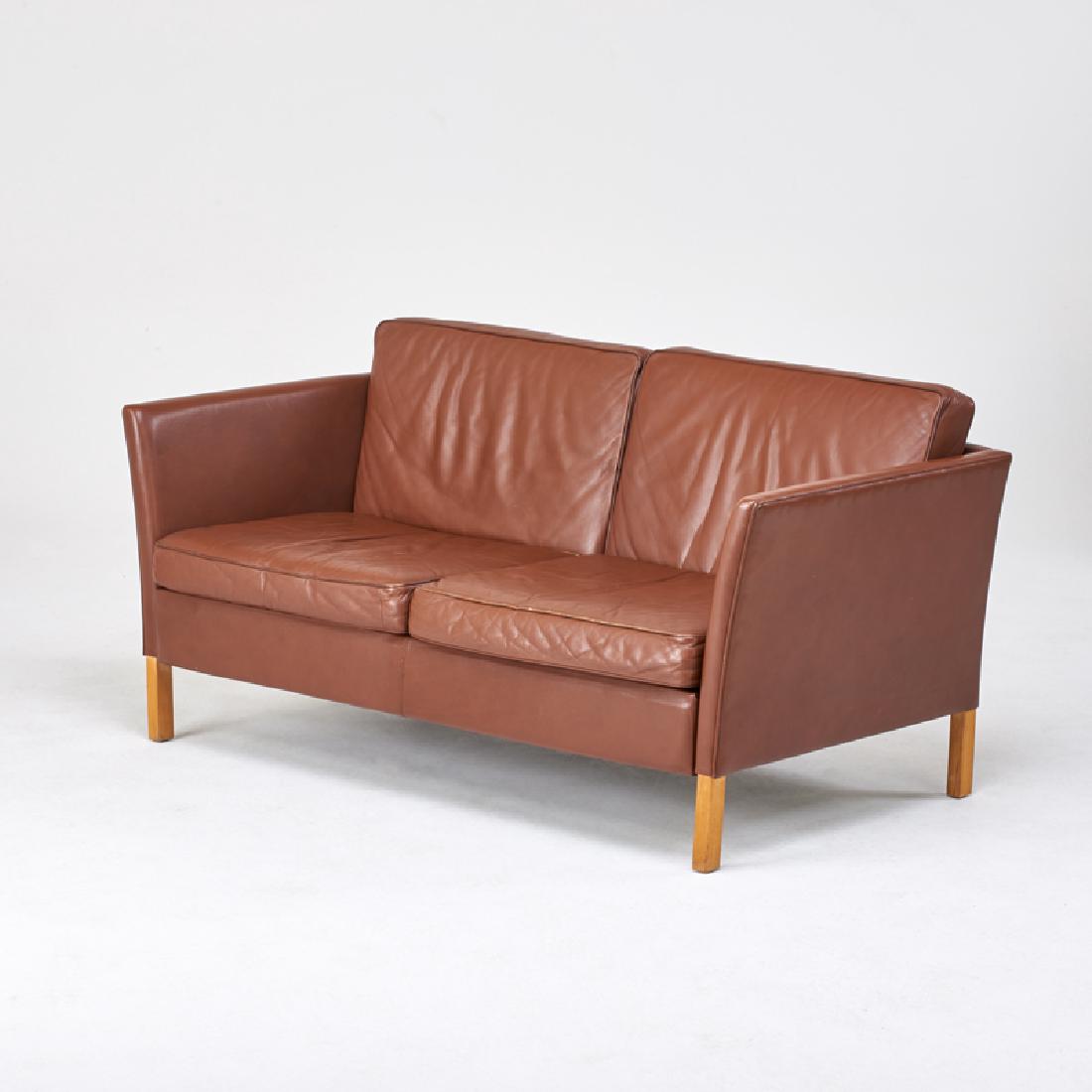 STYLE OF BORGE MOGENSEN: Two-seat sofa, Denmark, 1960s Leather, beech Danish control label 30" x 61 1/2" x 32"