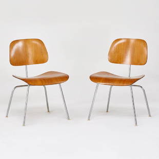 CHARLES AND RAY EAMES; HERMAN MILLER: Pair of DCMS, Zeeland, MI, 1960s Chromed steel, walnut, laminated plywood Manufacturer labels 30" x 19 1/2" x 22"