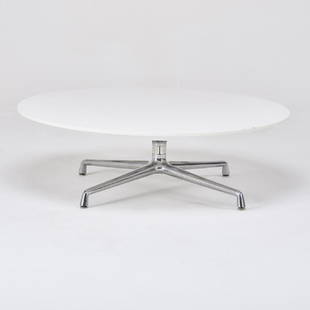 STEELCASE: Large, low coffee table, USA, 2000s Polished aluminum, laminated wood Manufacturer label 13" x 48" dia.