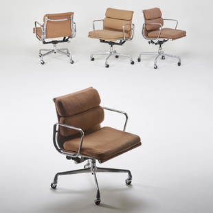 CHARLES AND RAY EAMES; HERMAN MILLER: Four Soft Pad armchairs, Zeeland, MI, 1990s Polished aluminum, chromed and enameled steel, cloth Manufacturer markings 31" x 23" x 24"