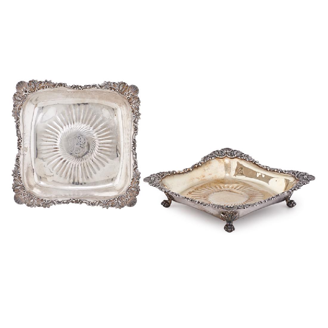 TIFFANY & CO. STERLING SILVER TAZZAS: Two: Both with applied shell and scroll border on claw and ball feet, one with silver-gilt interior, the other with monogram at center, USA, 1873-1902 Marked "6120/2659 T" and 6120/2824 M" 2 1/4" x 9