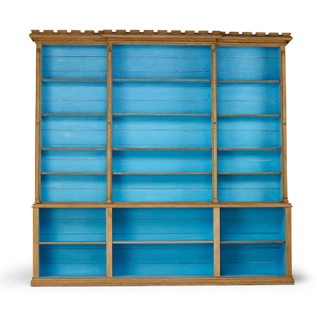 ENGLISH GOTHIC REVIVAL STYLE OAK BOOKCASE: With stripped surface and teal painted interior, England, 20th c. 108 1/2" x 110" x 10 1/2" Provenance: Property of a Lady, Brentwood, California