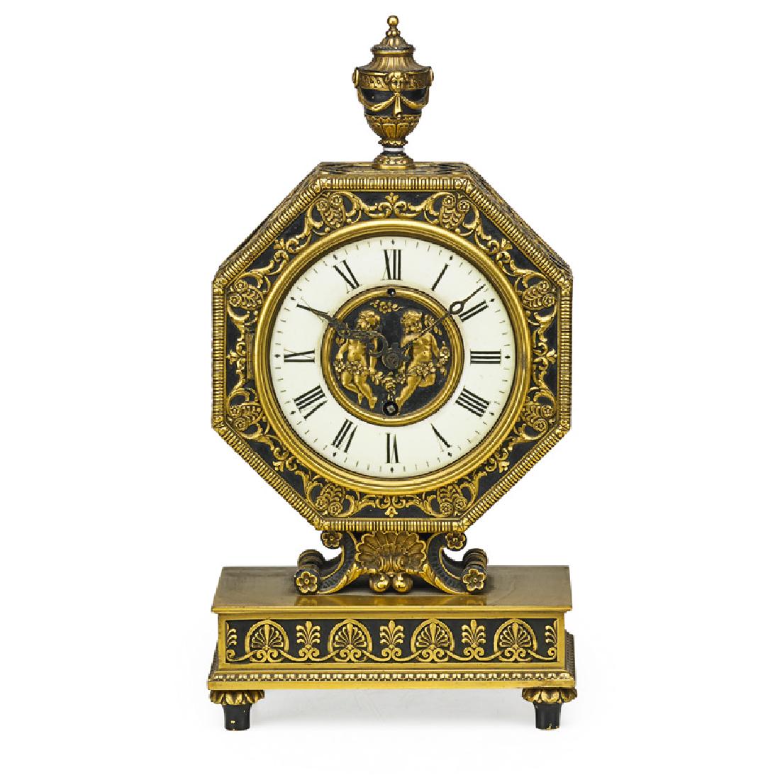 E.F. CALDWELL & CO. GILT BRONZE MANTEL CLOCK: Enamel face and central reserve of two cherubs, New York, late 19th/early 20th c. Inscribed "EDW. F. CALDWELL & CO., NEW YORK" 13 1/2" x 7" x 3 1/2"
