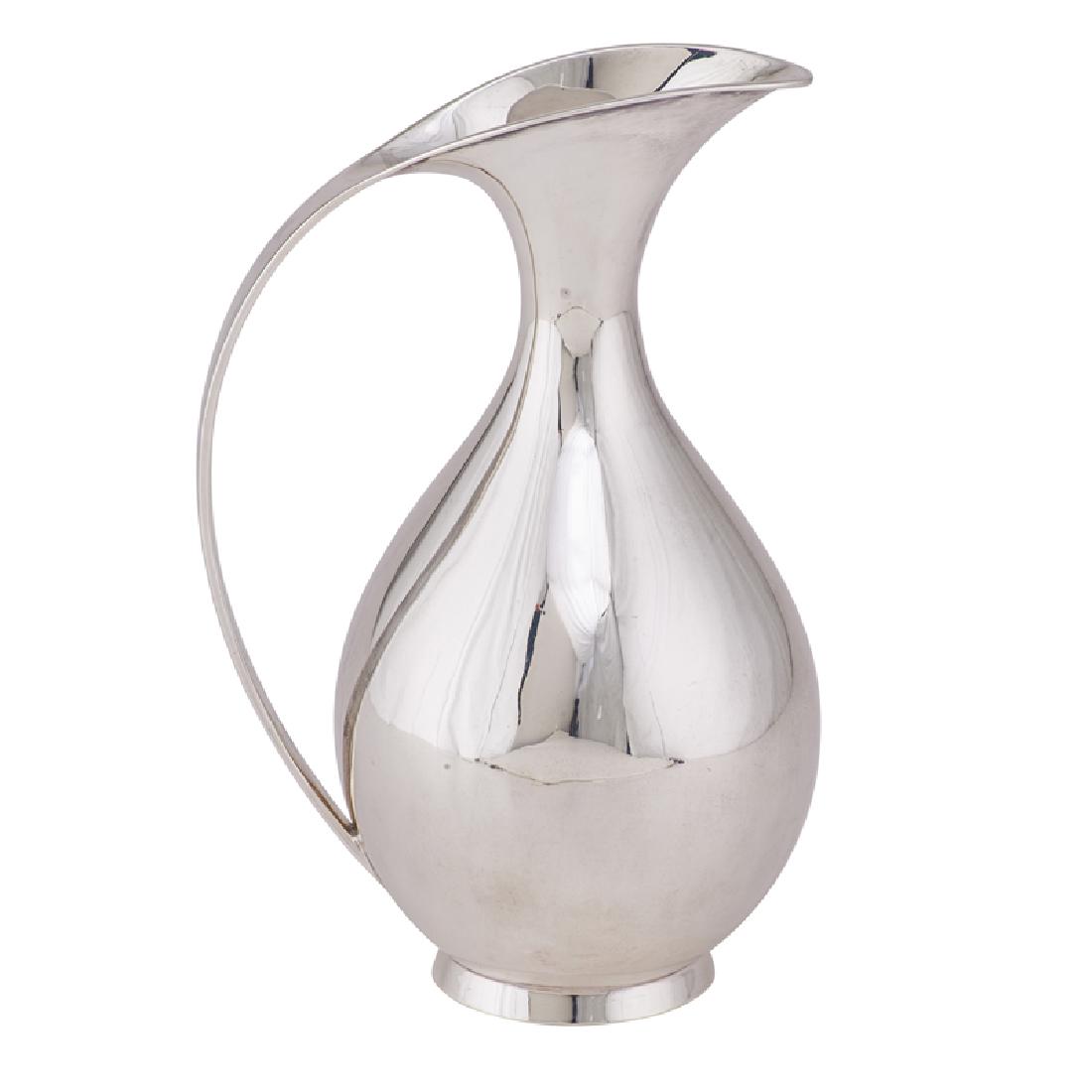 KAY FISKER A. MICHELSEN Pitcher: KAY FISKER (1893 - 1965) ANTON MICHELSEN Pitcher, Copenhagen, Denmark, 1947 Sterling silver Stamped A. MICHELSON STAINLESS DENMARK, 925S 1947, KAY FISKER, STERLING DENMARK 9" x 6" x 4 1/4" 18.99 OT