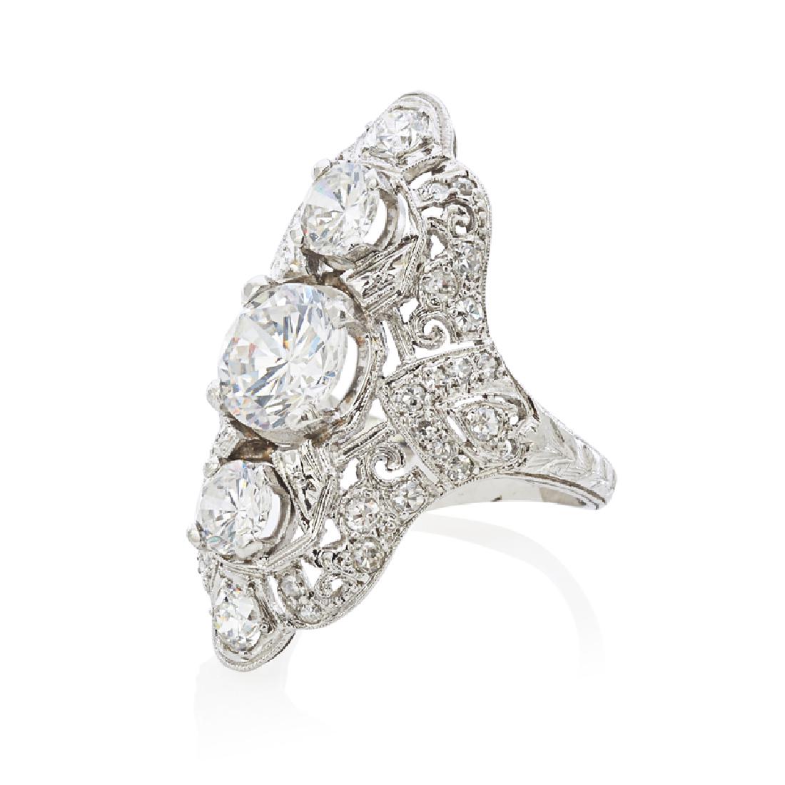 EDWARDIAN STYLE CUBIC ZIRCONIA & PLATINUM RING: With three prong-set RBC cubic zirconia vertically-set in a pierced and millegrained cubic zirconia set navette. Size 5 3/4. 5.1 dwt. Provenance: Estate of Peter K. and Kathleen B. Leisure, New York C