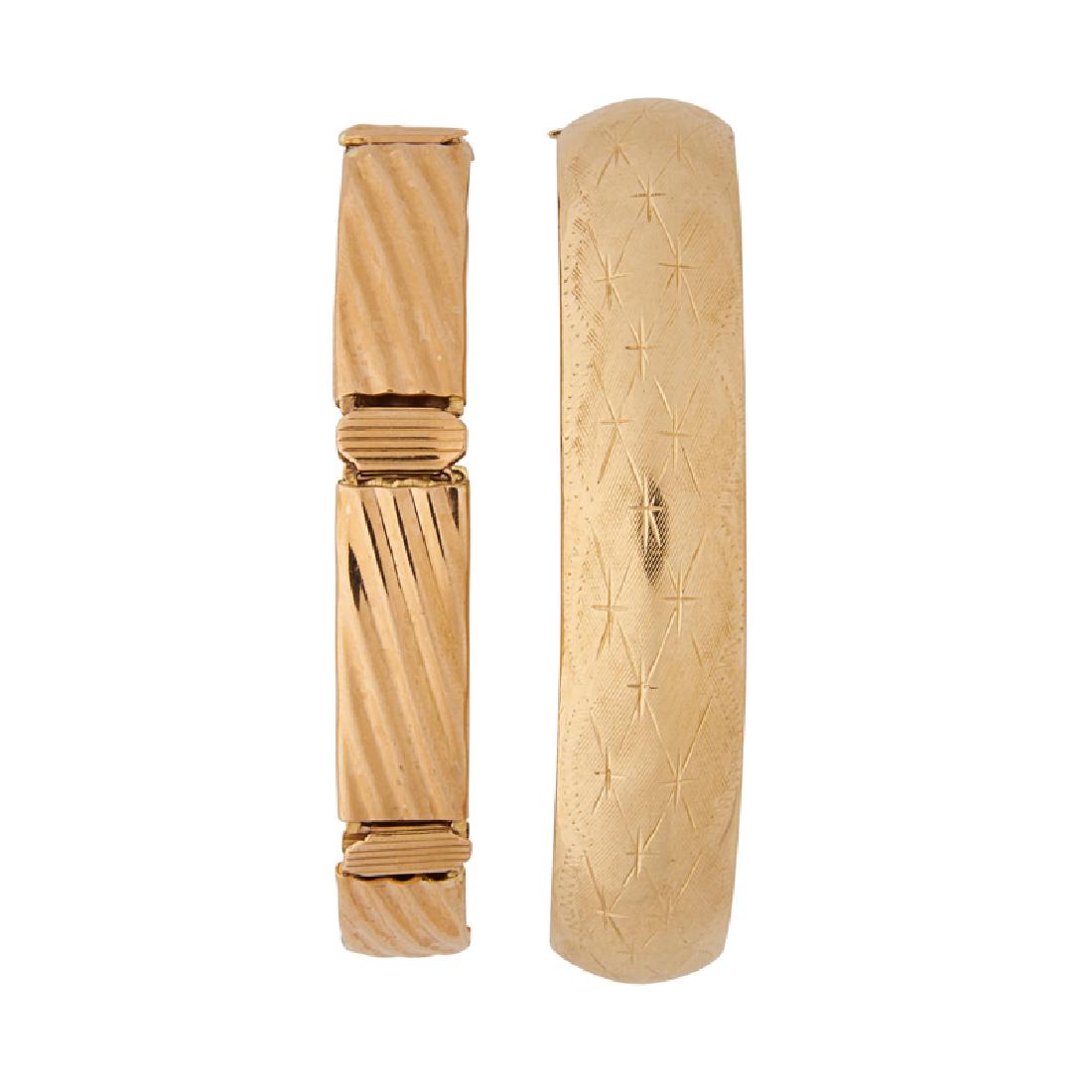 YELLOW GOLD BANGLE OR LINK BRACELETS: An engraved 10k gold bangle bracelet; A 14k gold conforming fluted link bracelet. Accommodates 7". 23.2 dwt.