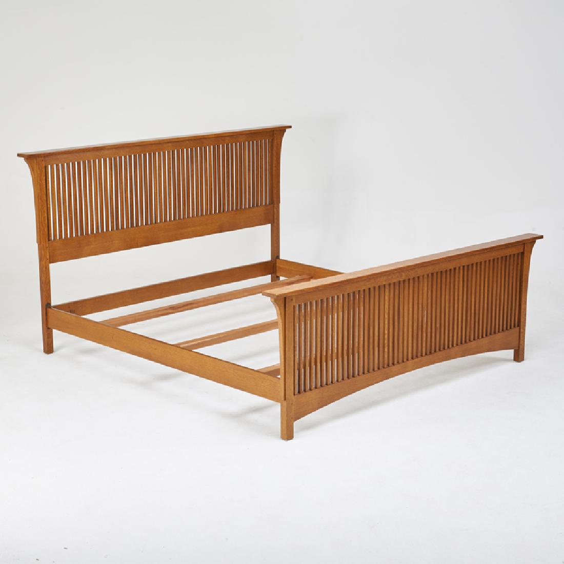 STICKLEY; E.J. AUDI: Contemporary king-size spindle bed with long corbels, in the style of L. & J.G. Stickley, Manlius, NY, 2000s Quartersawn oak Metal tag, branded mark 49 1/4" x 87" x 88"