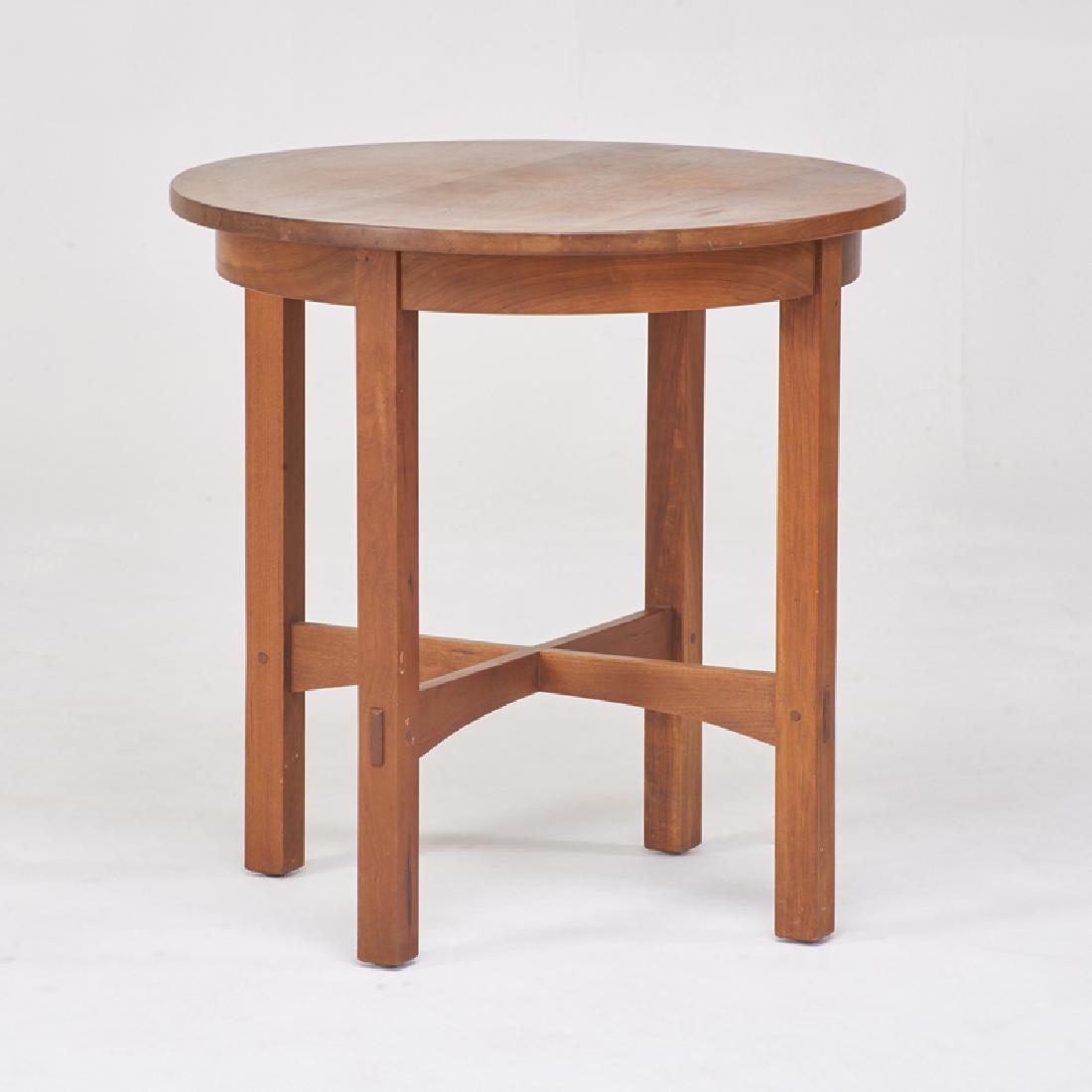 STICKLEY; E.J. AUDI: Contemporary circular lamp table with arched cross-stretchers, Manlius, NY, 1997 Cherry wood Metal tag, branded mark 26 1/4" x 26" dia.